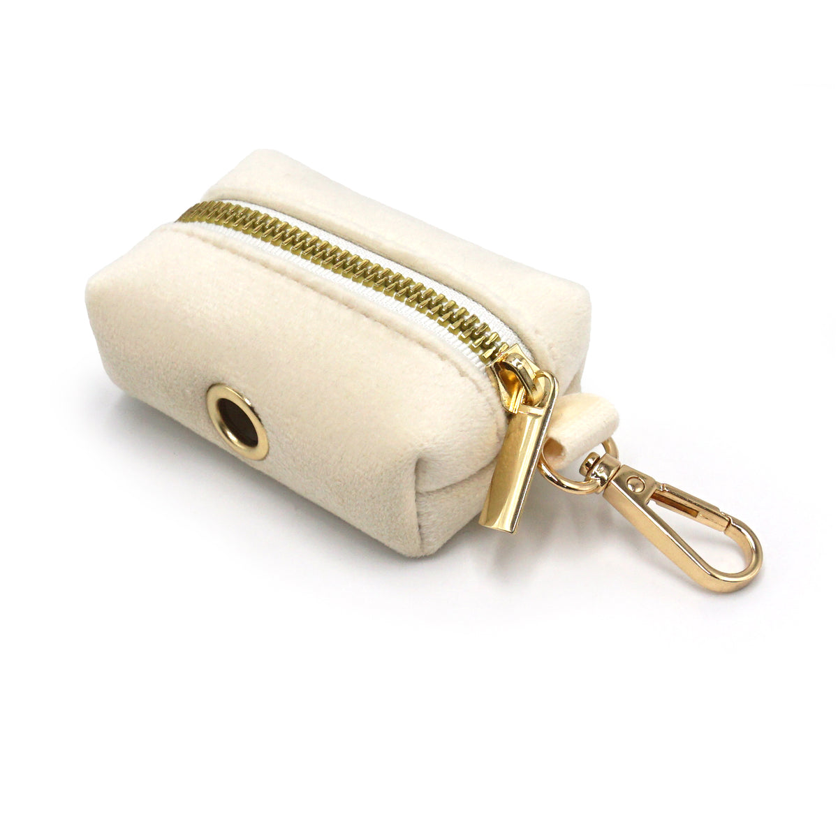 Creamy beige velvet poop bag dispenser with gold zipper and clip on a white background
