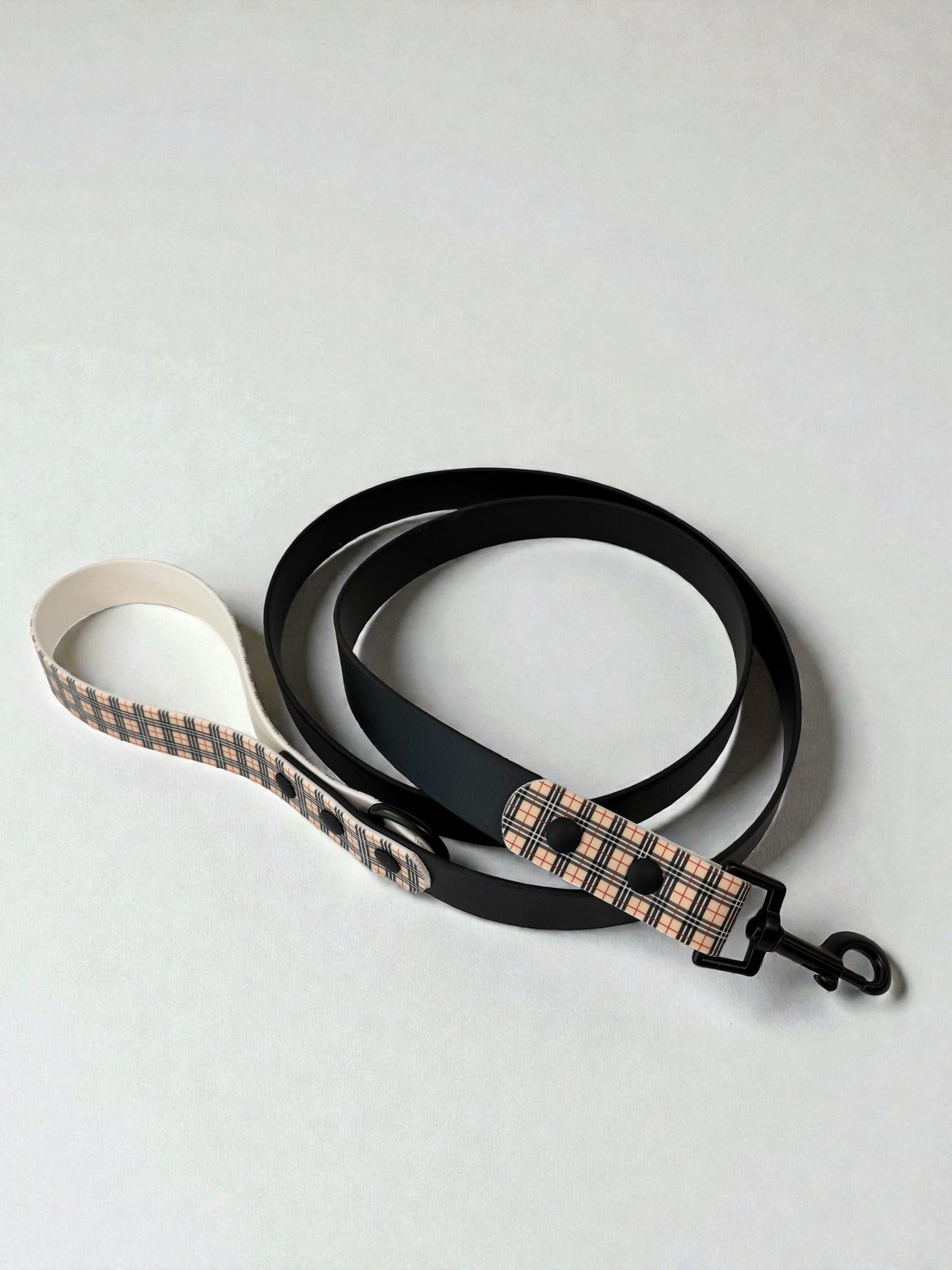 Dog leash with plaid pattern on a white background