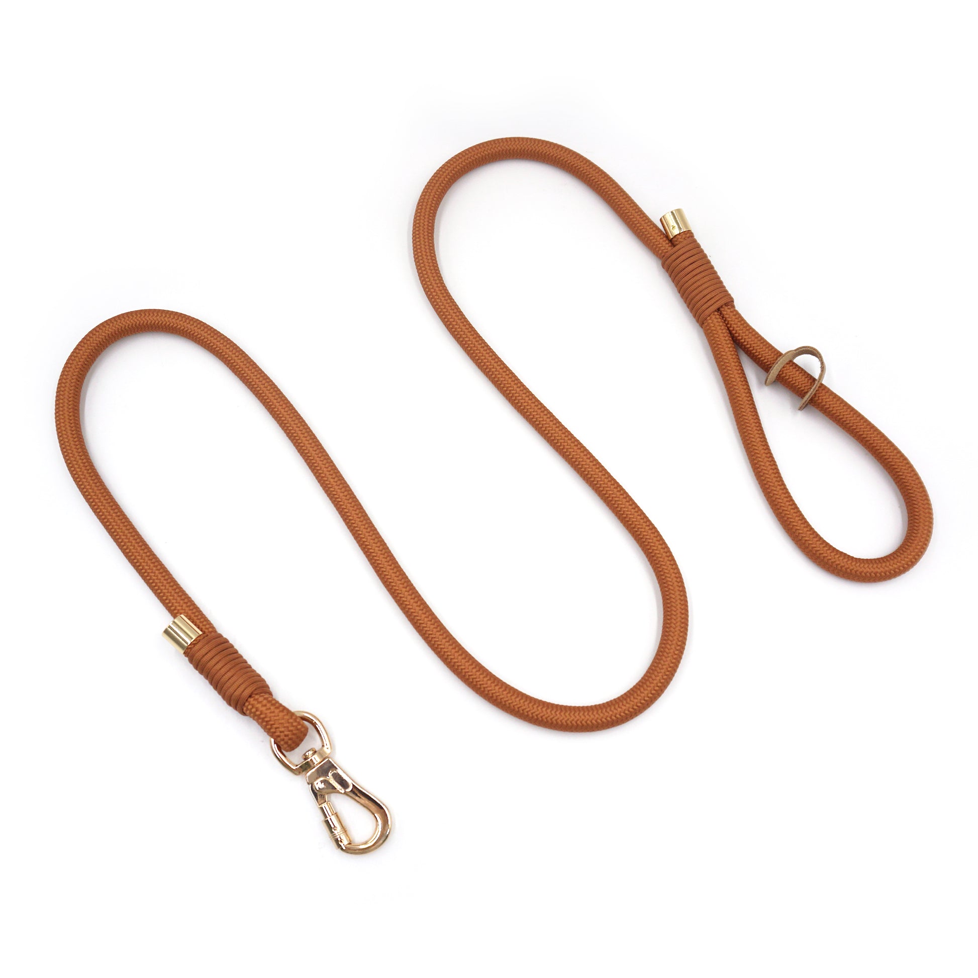 Warm brown rope dog leash with brass hardware on a white background