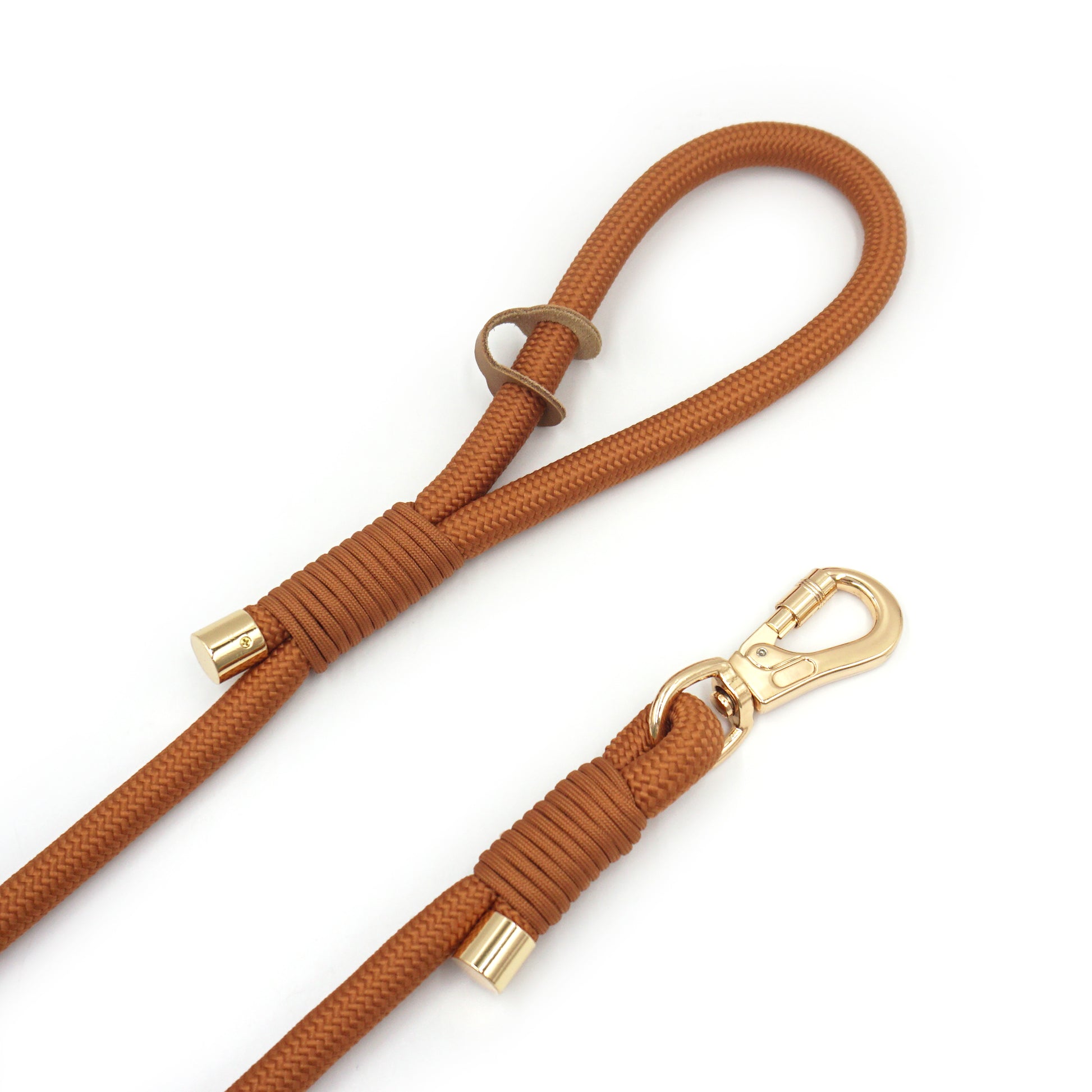 Warm brown rope dog leash with gold hardware on a white background