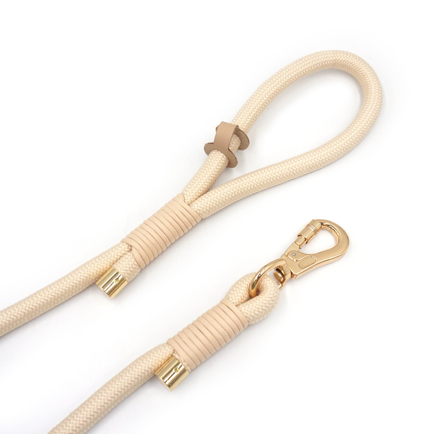 Creamy beige dog leash with gold hardware on a white background