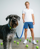 The Pickleball Biothane dog leash, held by a person with a Giant Schnauzer