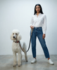 The British Plaid Biothane dog leash, held by a person walking a white Standard Poodle