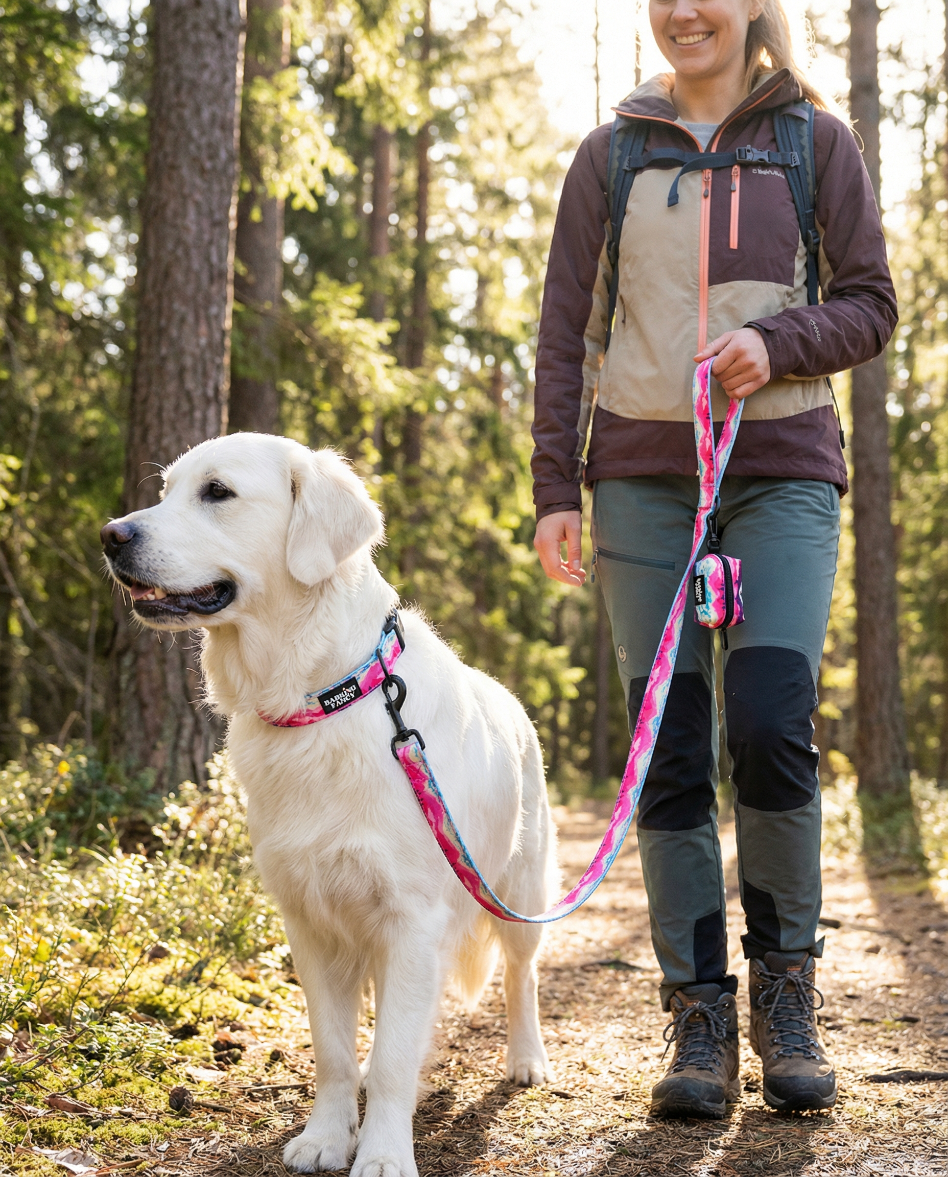 Woman walking a white dog on a leash in a forest