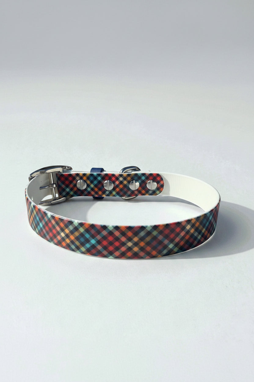 Back view of a plaid patterned dog collar with metal buckle on a white background