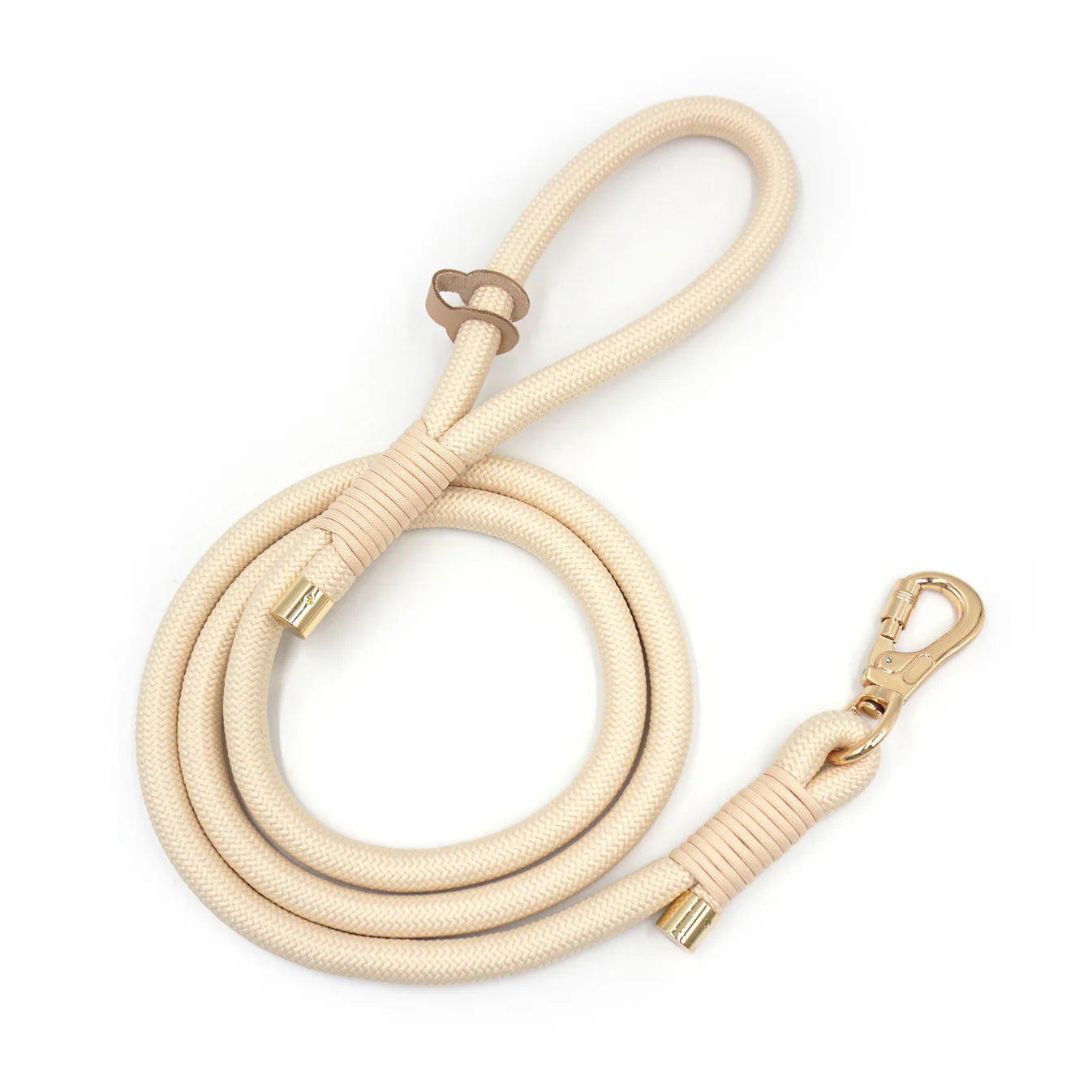 Creamy beige rope dog leash with gold clasp on a white background