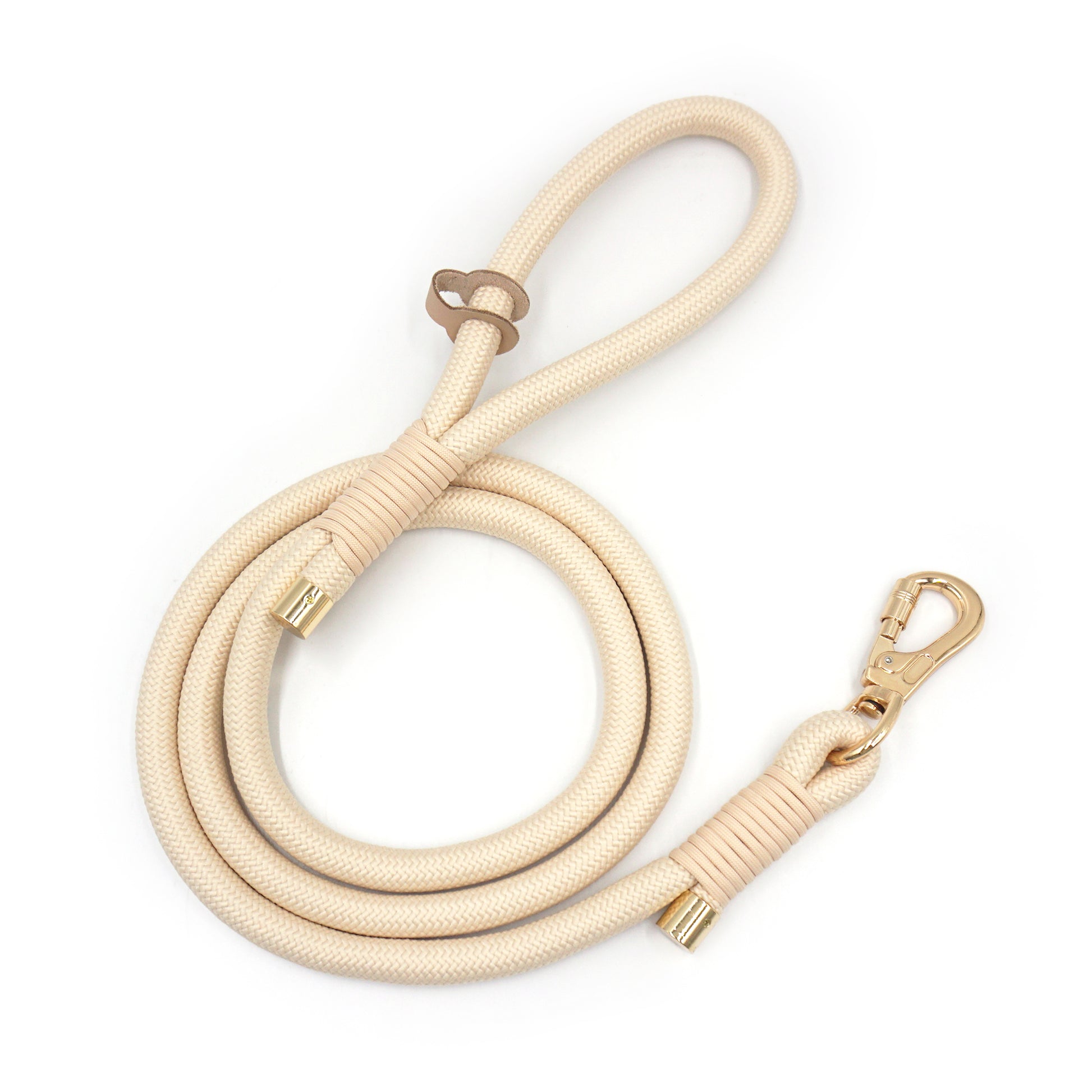 Beige rope dog leash with gold clasp on a white background