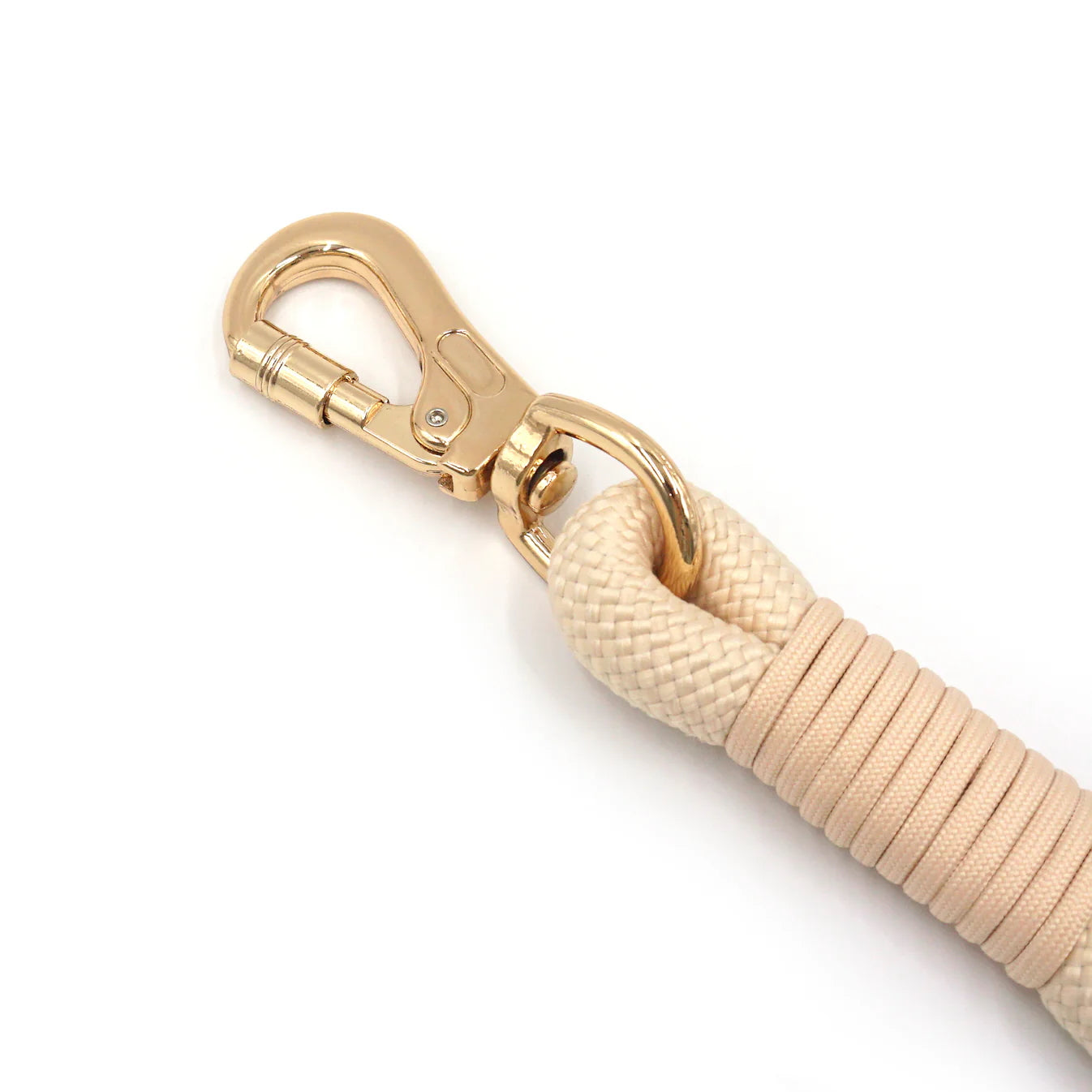 Closeup of creamy beige rope leash with gold clasp on a white background