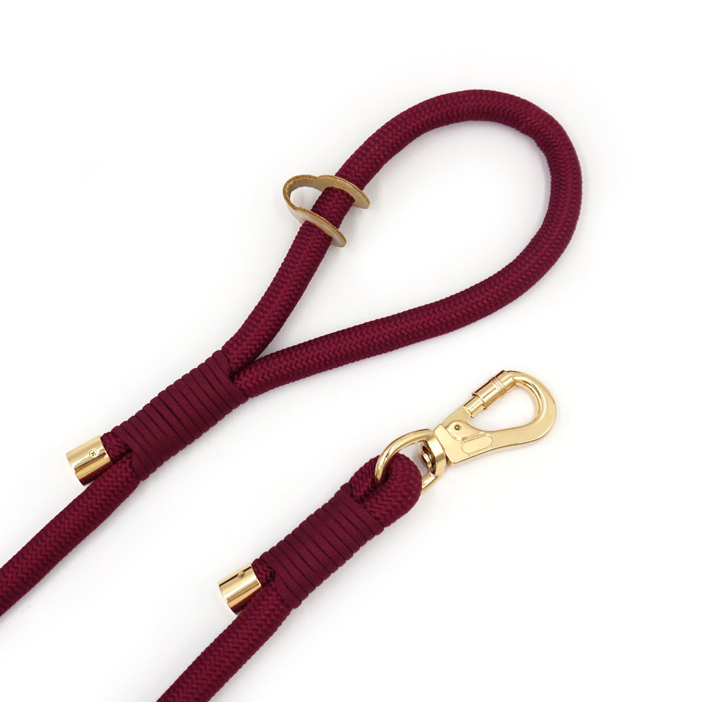 Burgundy rope dog leash with gold hardware on a white background